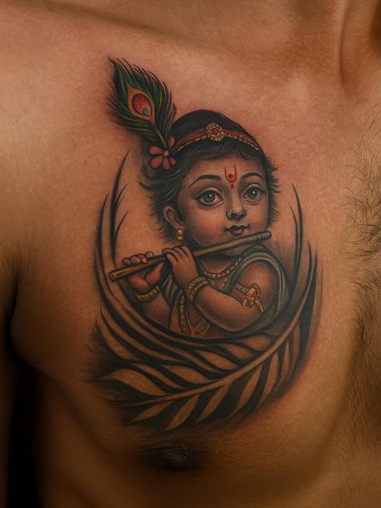 This chest tattoo of Bal Krishna (baby Krishna) is a symbol of divine innocence and love. I used soft shading to create a realistic and gentle portrait, focusing on his playful eyes and the delicate peacock feather in his hair. It’s a piece that sits right over the heart.