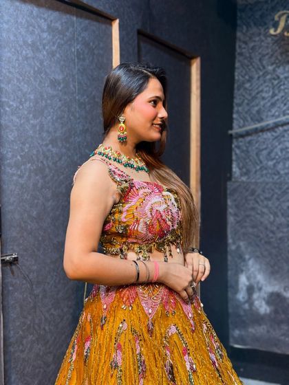 A side profile of the yellow Haldi lehenga, showing the beautiful back design of the blouse.
