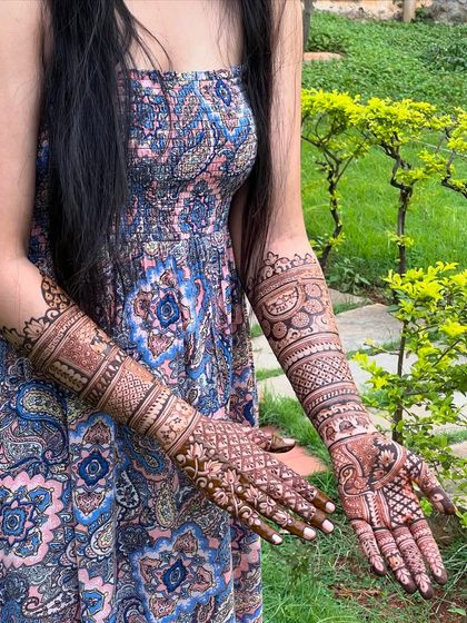 Another angle of the beautiful bridal mehendi, captured in a natural outdoor setting.
