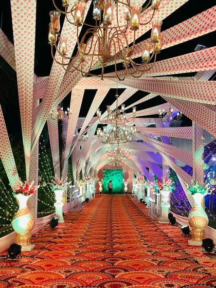 A closer look at the crisscross fabric ceiling of this Sangeet entrance. The design is complex but creates a beautiful, structured canopy over the walkway.
