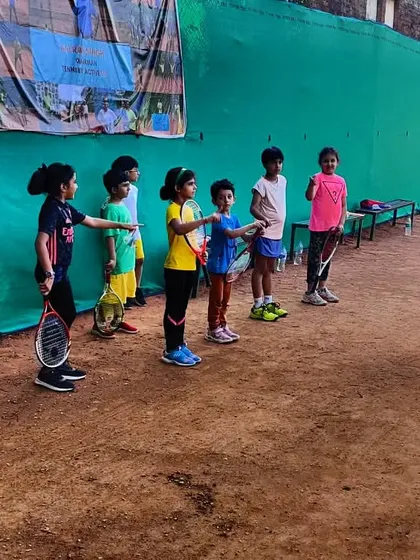 Young players lined up on the clay court during a weekend tournament, learning the rules and structure of the game in a friendly environment.