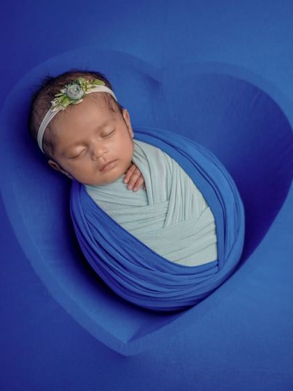 Sleeping soundly, dreaming big. This simple, classic swaddle pose is perfect for capturing the peacefulness of a newborn.