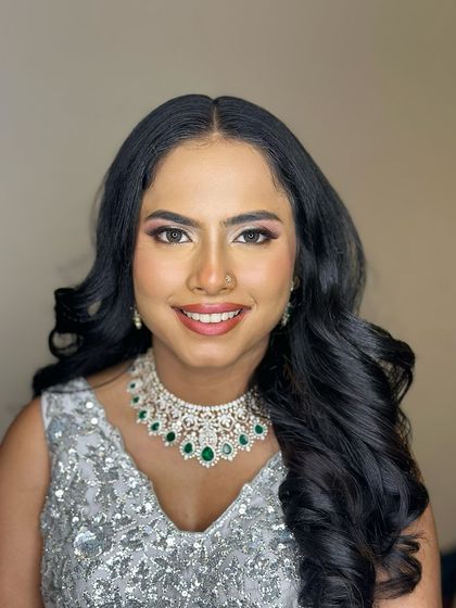 A happy, smiling portrait, her makeup enhancing her joyful expression.