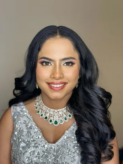 A happy, smiling portrait, her makeup enhancing her joyful expression.