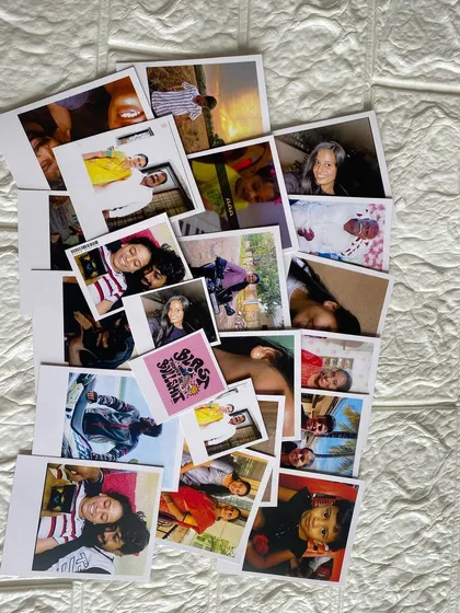 A colorful collage of freshly printed Polaroids, ready to be sent to their new home. Each print captures a unique memory, from travel adventures to simple, happy moments.