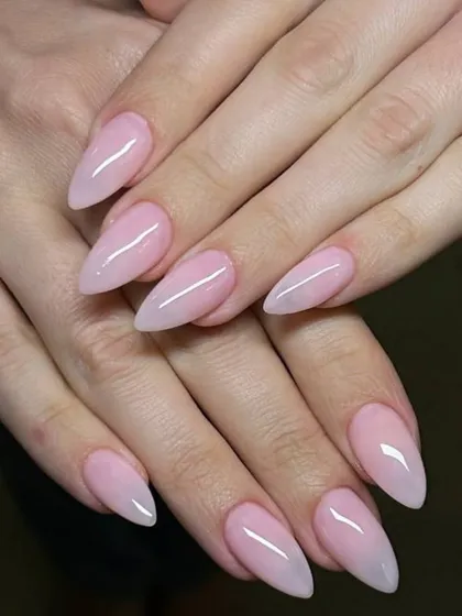 A soft, milky pink ombré on almond-shaped nails. The gradual fade is subtle and incredibly elegant.