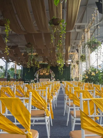 A daytime view of the Sky Terrace seating arrangement, showcasing the yellow chair sashes and the spacious layout ready for a celebration.
