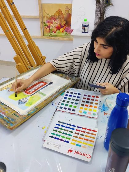 The process of creating a watercolor street scene, from the initial sketch to the final color washes.