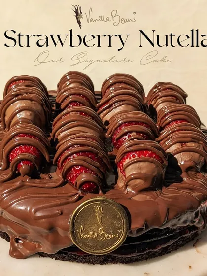 Our signature Nutella Strawberry cake, ready for its close-up. Topped with fresh strawberries dipped in chocolate and drizzled with even more Nutella, it's a true indulgence.