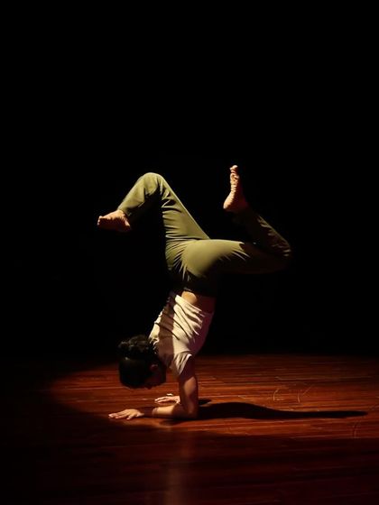 A contemporary dancer showcases incredible strength and balance during the "Parabola of Dance." We provide a platform for diverse dance styles, from classical to modern.