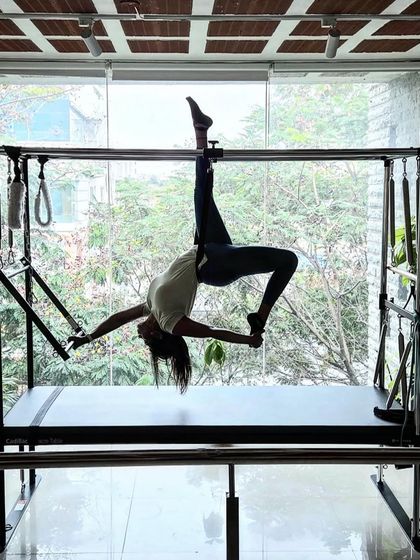 This is a beautiful expression of strength and flexibility on the Cadillac. The 'Spread Eagle' pose opens the hips and chest while requiring significant core and upper body strength to hold the position.