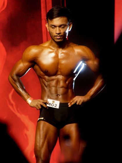 Posing for the judges. This front-on shot displays the symmetry and conditioning he brought to the ICN stage.