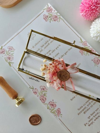 A single invitation scroll, elegantly placed in a glass keepsake box. This presentation elevates the invitation from a simple notice to a cherished memento of the special day.