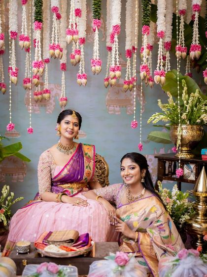 A quiet moment of connection between the bride and a loved one. The traditional setting, with its soft colors and fragrant flowers, enhances the emotional depth of the occasion.
