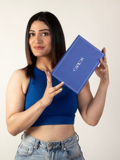 A confident pose from a model holding the hair extension box, ideal for website banners and social media.