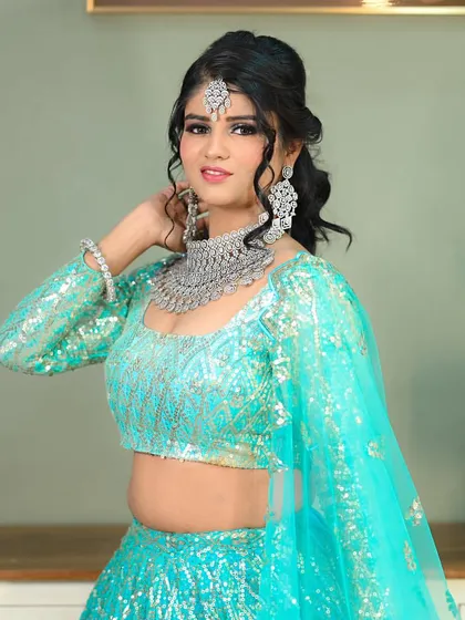A full portrait of the model in a glamorous light blue lehenga, perfect for a sangeet or reception look.