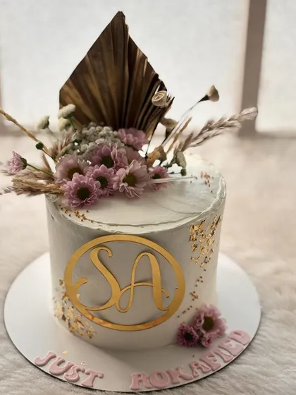 A chic and rustic cake for a roka ceremony. I used dried palm leaves, pampas grass, and delicate daisies with gold leaf for a modern bohemian vibe.