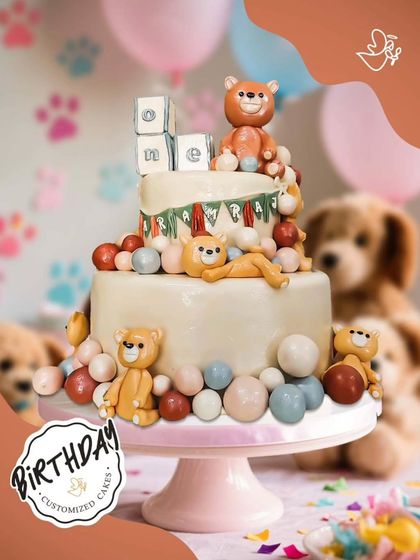 A cuddly and cute cake for a first birthday, covered in adorable teddy bears and colorful balls. A perfect centerpiece for a "beary" special day.
