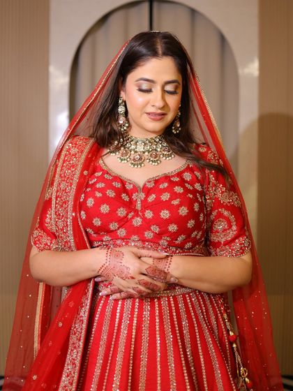 A close-up of the bride-to-be, her face glowing with happiness. The detailed embroidery on the blouse and the matching jewelry complete the look.