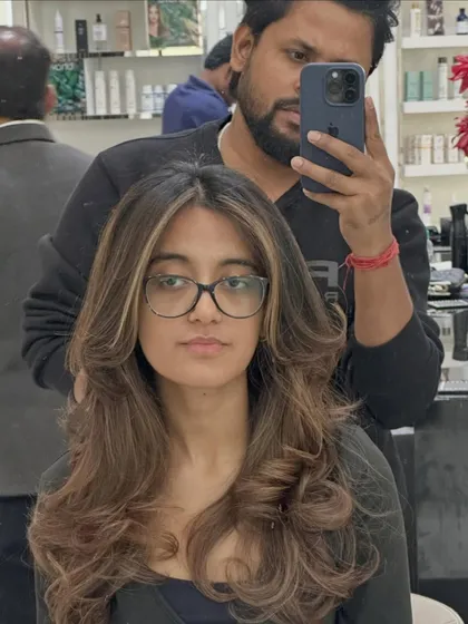 A selfie with the client, showing off her refreshed color. The highlights are perfectly placed to complement her features, even with glasses on.