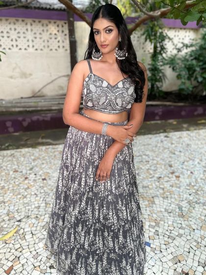 A full-length view of the client in the grey Indo-Western lehenga.