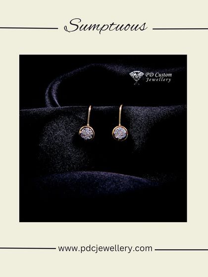 Sumptuous and simple, these 18kt hallmarked gold diamond earrings feature a single diamond cluster in a dangling bezel setting. Perfect for a minimalist look.