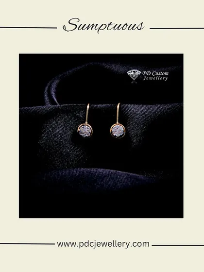 A sumptuous pair of diamond hoop earrings in 18kt gold. The simple, elegant design with a cluster of diamonds is perfect for a sophisticated look.