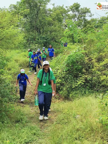 A student confidently leads the way on a path through the lush greenery. Our programs aim to build confidence and a sense of belonging in nature.