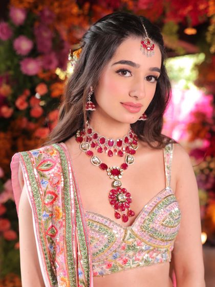 A close-up portrait showing the beautiful ruby jewelry and the soft, pretty makeup that makes her look like a princess.