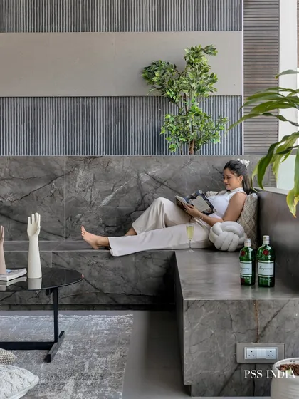 A lifestyle shot showing someone enjoying the comfort of the marble deck. This image perfectly captures the idea of creating a personal sanctuary where you can unwind with a drink and a good book.