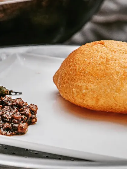 The ultimate comfort food, Chole Bhature, served with style. A fluffy, perfectly puffed bhatura paired with spicy chickpea curry is a classic combination that never disappoints.
