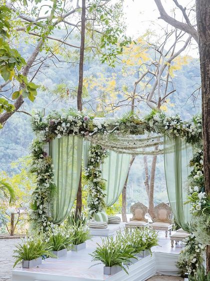 A wide shot of the beautiful mandap, framed by trees and overlooking the hills.