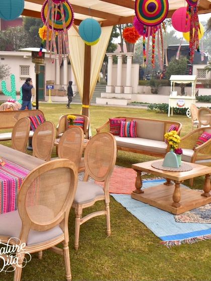 A lounge area with colorful hanging decorations, dreamcatchers, and vibrant cushions, creating a bohemian-fiesta vibe.