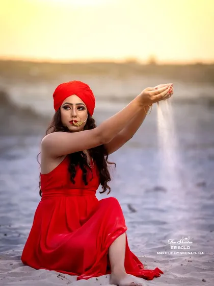An artistic shot showing the model letting sand fall through her hands, capturing a moment of storytelling within our conceptual shoot.