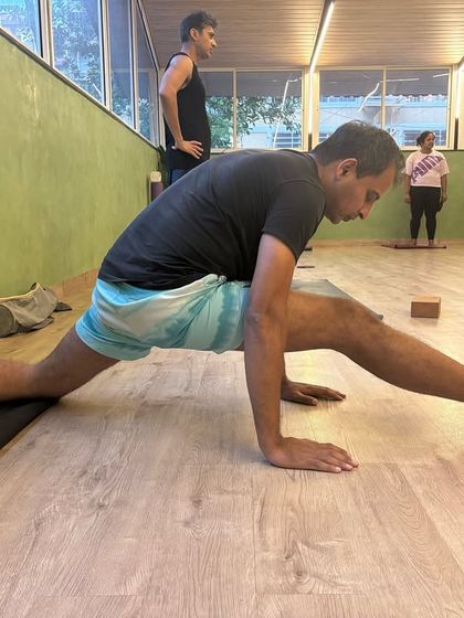 Men do yoga too. Here, a member works on his front splits, proving that flexibility is for every body.