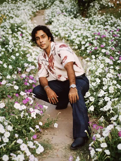 A slightly different angle of Zahan Kapoor in the flower patch, showing more of the path and creating a sense of journey.