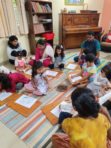 Parents help their children with the coloring, making it a supportive and encouraging activity.