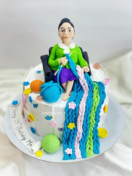 A cake for a mom who loves knitting, ordered by her son for her leap year birthday. The design features an edible caricature and colorful balls of yarn.
