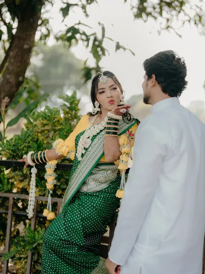 A playful moment between the couple during their Haldi ceremony. The bride blowing a kiss to her groom is a perfect candid shot, full of fun and love.