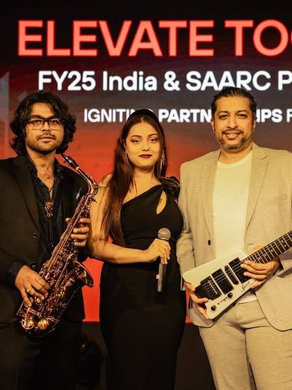 The AMC Trio posing on stage at the PaloAlto summit. We offer scalable band options, and our trio is a popular choice for sophisticated corporate functions.