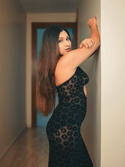 We shot this in a simple hallway, using the narrow space to create a sense of intimacy. The single light source creates a moody, dramatic effect that highlights the texture of the dress.