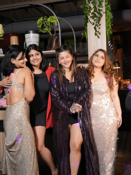 A group of ladies looking glamorous and celebrating together.