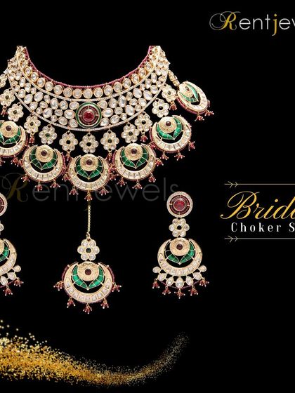 This Polki Kundan Meenakari bridal necklace set combines classic green and red for a traditional look. It's a perfect choice for any main wedding function.
