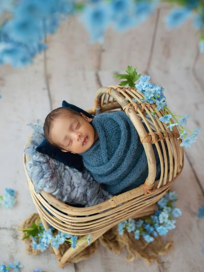 Color theory is a key part of my workshop. In this setup, we used shades of blue in the wrap, flowers, and props to create a cohesive and calming portrait of this sweet baby boy.