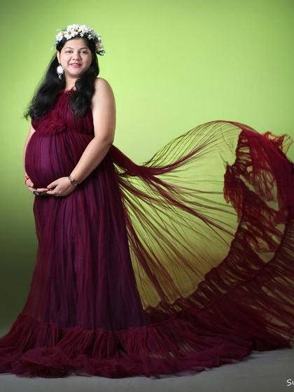 This studio shot shows the "flying" trail of the wine-colored gown. It's a versatile dress that works for both static portraits and action shots.
