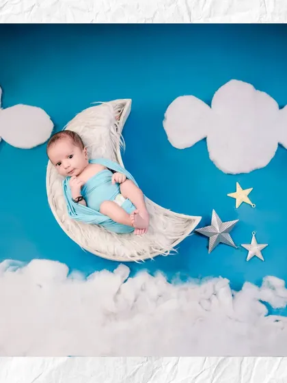I believe in creating fairytale moments for your baby. This celestial-themed shoot features a baby resting on a crescent moon prop, surrounded by dreamy clouds and stars in my studio.