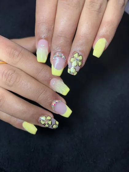 A bright and cheerful set with yellow French tips, ombre, and accent nails with 3D flowers and crystal centers.