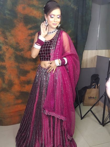 A beautiful magenta lehenga with silver sequin work. This client is getting ready for a party, looking stunning in her rental outfit.