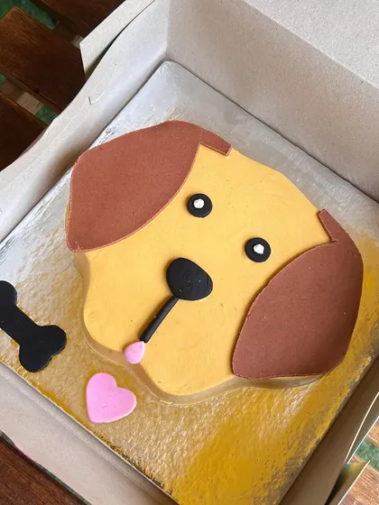 A simple and sweet dog-face cake, ready to go. We can create designs for any breed, capturing their essence in a fun, minimalist style.