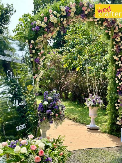 A closer look at the stunning floral arch, overflowing with pastel roses and purple blooms. It created a perfect frame for photos and a magical entrance for the guests.
